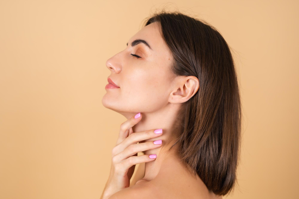 Woman with healthy skin and manicured pink nails